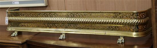 A Regency embossed and pierced brass kerb W.135cm